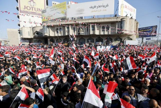 Supporters of prominent Iraqi Shi'ite cleric Moqtada al-Sadr shout slogans during a protest in Baghdad