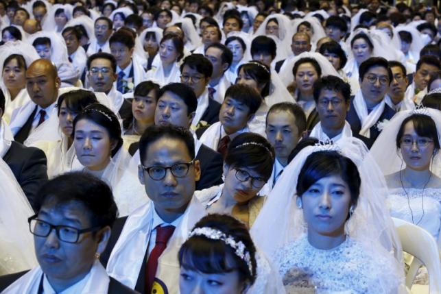 Newlywed couples attend a mass wedding ceremony of the Unification Church at Cheongshim Peace World Centre in Gapyeong