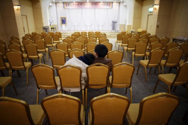 A couple takes their seat before an orientation for upcoming mass wedding ceremony of the Unification Church at a resort in Yangpyeong