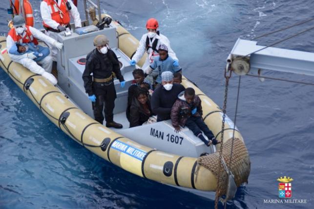 Marina Militare handout photo shows migrants sitting on a rescue boat of the Italian naval vessel Bettica during a rescue operation