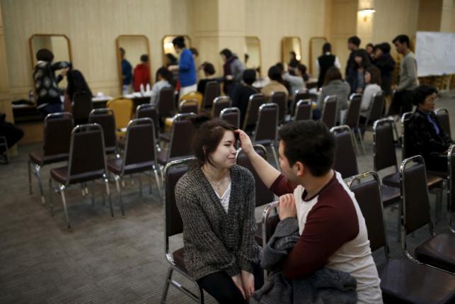 Meena Okamoto of U.S talks with her groom Jaronce Dutil of Canada as they prepare for upcoming mass wedding ceremony of the Unification Church at a resort in Yangpyeong