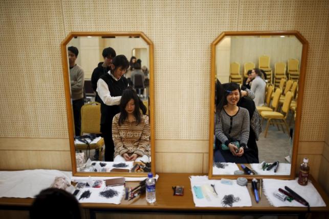 Japanese brides receive a makeover as they prepare for upcoming mass wedding ceremony of the Unification Church at a resort in Yangpyeong