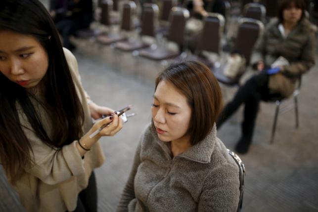 A Japanese bride receives a makeover as she prepares for upcoming mass wedding ceremony of the Unification Church at a resort in Yangpyeong