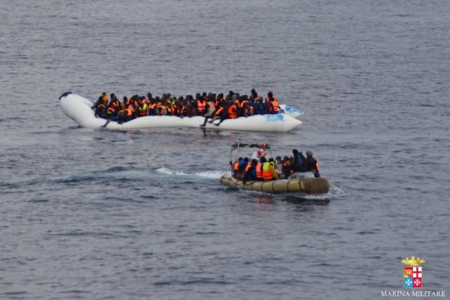 Marina Militare handout photo shows migrants sitting in their boat during a rescue operation of 219 migrants by Italian naval vessel Bettica