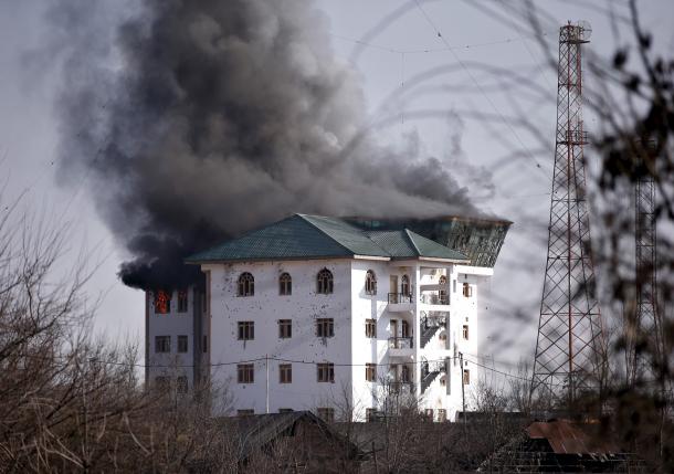 Smoke billows from a building, in which Indian authorities say suspected militants are holed up, during a gun battle on the outskirts of Srinagar