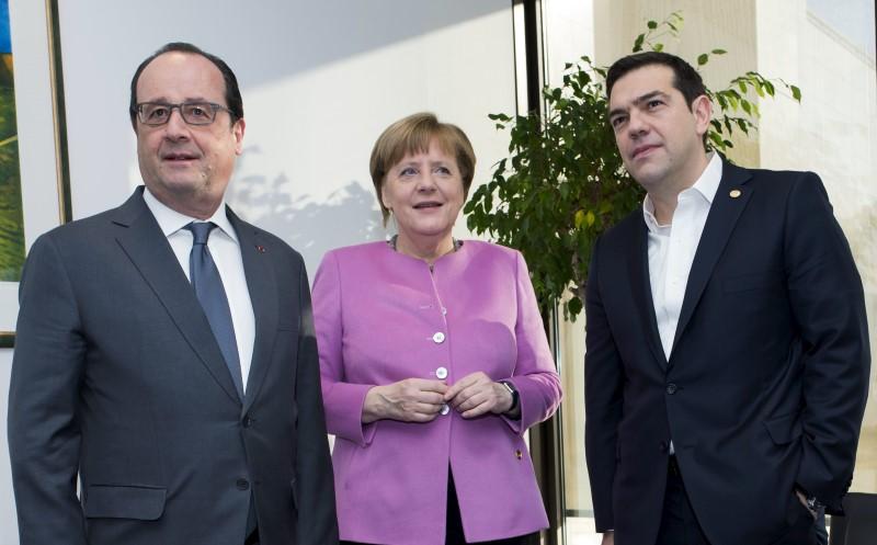 French President Francois Hollande talks with German Chancellor Angela Merkel and Greek Prime Minister Alexis Tsipras during a European Union leaders summit in Brussels