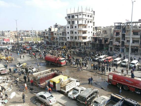 A general view shows the site of a two bomb blasts in the government-controlled city of Homs