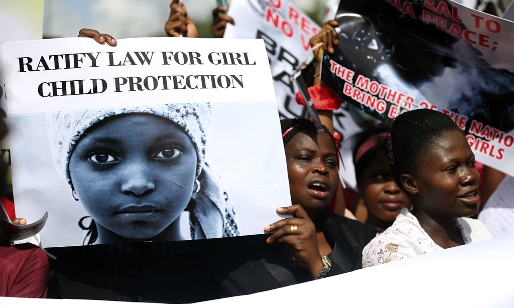 Woman holding signs take part in a protest demanding the release of abducted secondary school girls from the remote village of Chibok, in Lagos