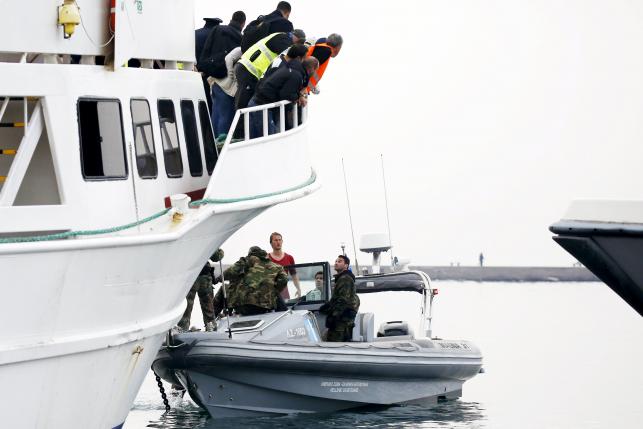 An activist who tried to prevent a Turkish-flagged passenger boat carrying migrants to be returned to Turkey from leaving the port of Mytilene, is seen in a Greek Coast Guard speedboat near Greek island of Lesbos