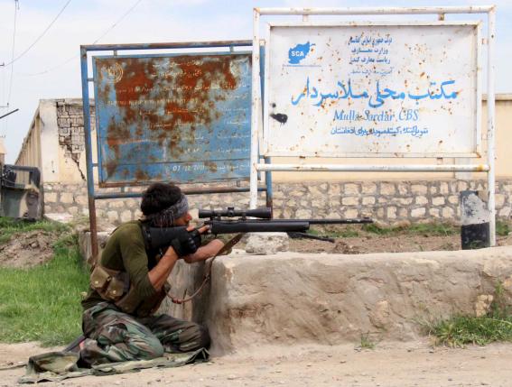 A member of Afghan security force takes his position during a battle with the Taliban on the outskirts of Kunduz province