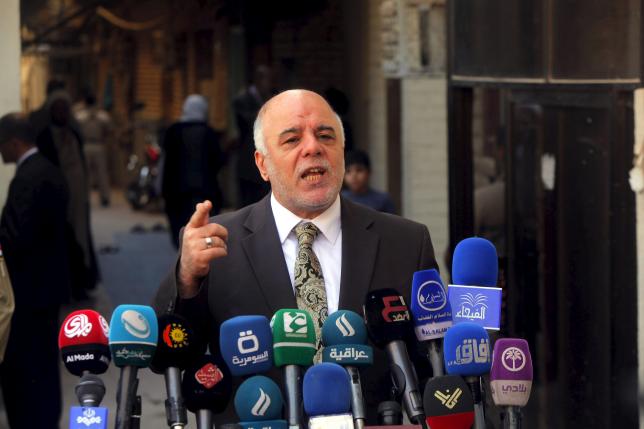 File photo of Iraqi PM Haider al-Abadi at news conference during visit to Najaf, south of Baghdad