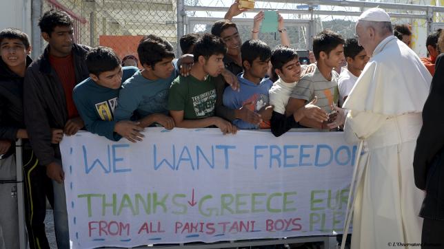 Pope Francis greets migrants and refugees at the Moria refugee camp near the port of Mytilene, on the Greek island of Lesbos