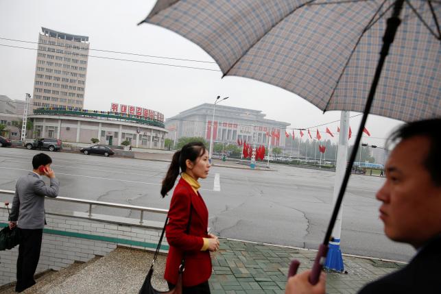 People walk on a road near the venue of a ruling party congress in Pyongyang