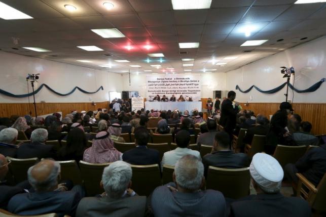 Bureau members of a preparatory conference to announce a federal system discuss a "Democratic Federal System for Rojava - Northern Syria" in the Kurdish-controlled town of Rmeilan, Hasaka province
