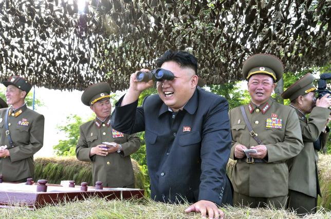 KCNA file photo showing North Korean leader Kim Jong Un looking through a pair of binoculars during inspection of Hwa Islet Defence Detachment off east coast of Korean peninsula