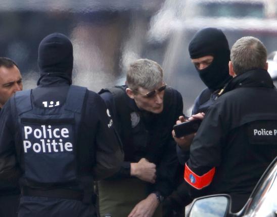 Police take part in a search in the Brussels borough of Schaerbeek following Tuesday's bombings in Brussels.