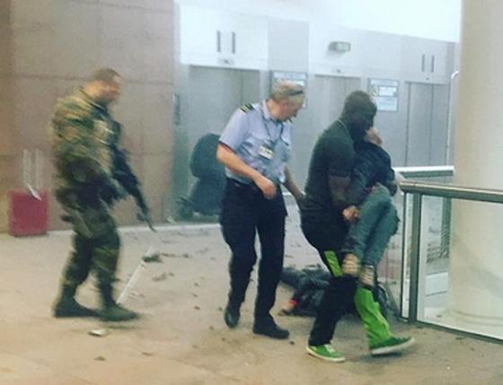 Injured people are seen at the scene of explosions at Zaventem airport near Brussels