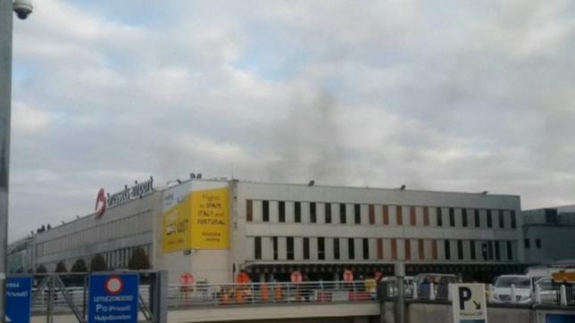 Still image shows black smoke rising from the Brussels airport following explosions