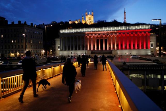 The black, yellow, and red colors of the Belgian flag are projected on the courthouse in Lyon in tribute to the victims of today's Brussels bomb attacks