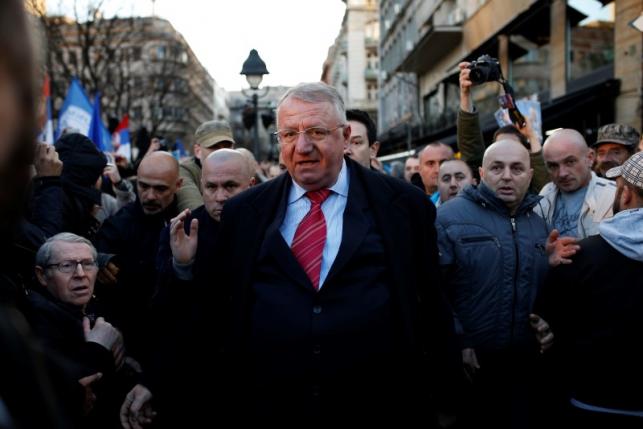 Serbian ultra-nationalist leader Seselj surrounded by his supporters arrives for an anti-government rally in Belgrade