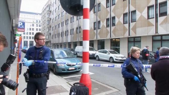 Still image taken from video of emergency personnel at the scene of a blast outside a metro station in Brussels