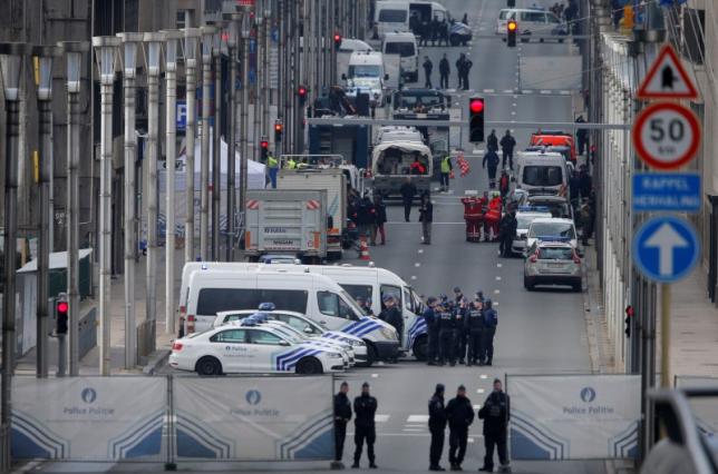 Belgian police and emergency personnel secure the Rue de la Loi following an explosion in Maalbeek metro station in Brussels