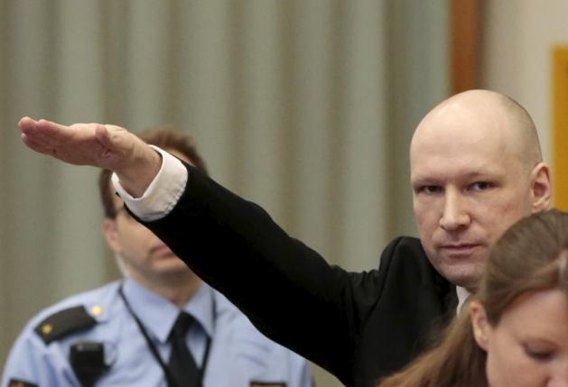 Mass killer Anders Behring Breivik raises his arm in a Nazi salute as he enters the court room in Skien prison