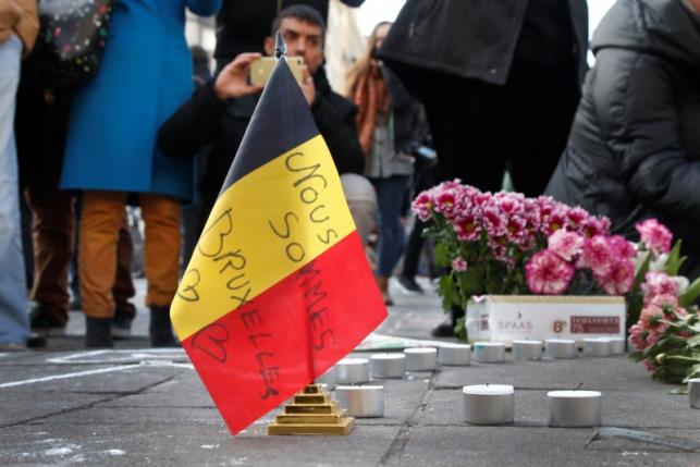 People gather around a memorial in Brussels following bomb attacks in Brussels, Belgium