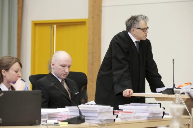 Mass killer Anders Behring Breivik sits in between his lawyers Mona Danielsen (L) and Oystein Storrvik at the court room in Skien prison