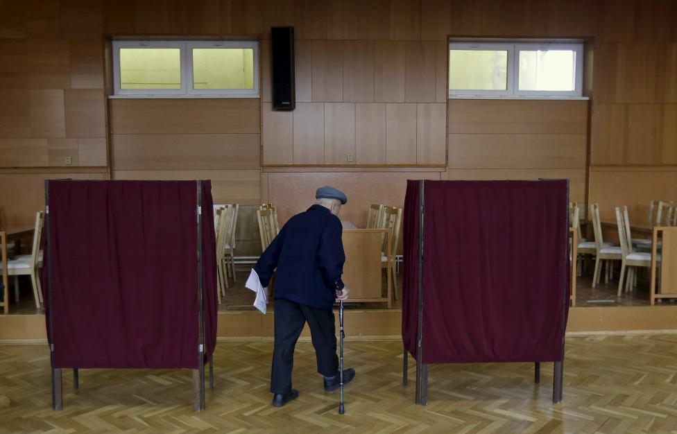 A voter arrives to cast his ballot at a polling station during the country's parliamentary election in Ruzindol
