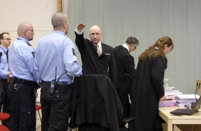 Mass killer Anders Behring Breivik raises his arm in a Nazi salute as he enters the court room in Skien prison