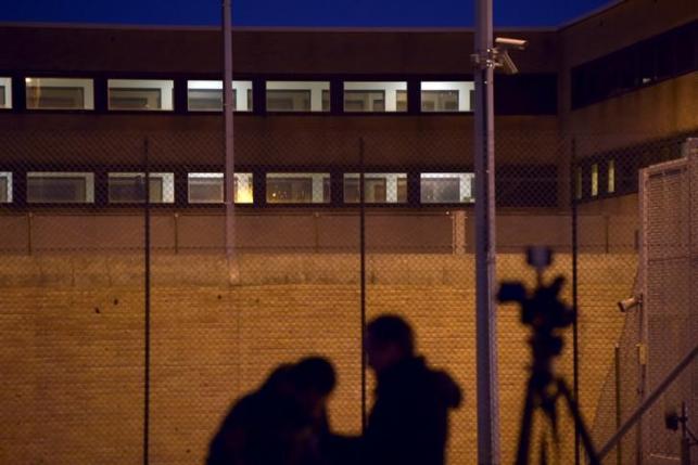 Reporters stand in front of a prison in Bruges where Salah Abdeslam is being held, Belgium