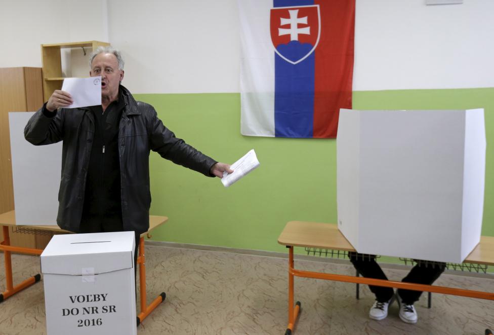 A voter reacts before casting his ballot at a polling station during the country's parliamentary election in Trnava