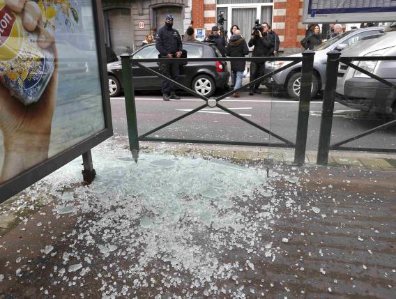 Broken glass from a tramway stop shelter is seen after shots were fired during a search in the Brussels borough of Schaerbeek