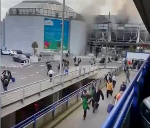 Still image shows people fleeing from Brussels airport shot by bystander in immediate aftermath of blasts at the airport near Brussels