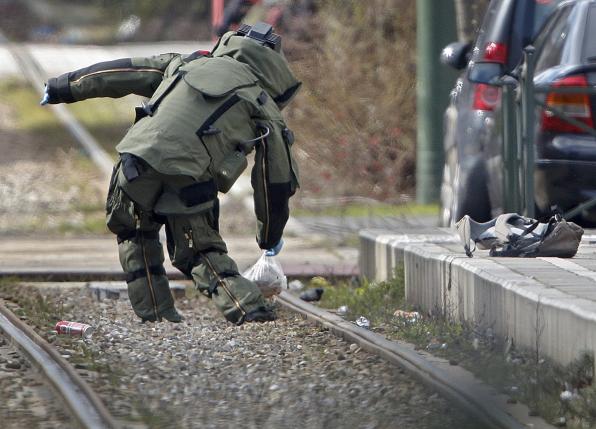 A bomb disposal expert takes part in a search in the Brussels borough of Schaerbeek following Tuesday's bombings in Brussels.