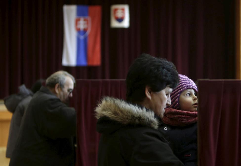 Voters prepare to cast their ballots at a polling station during the country's parliamentary election in Ruzindol