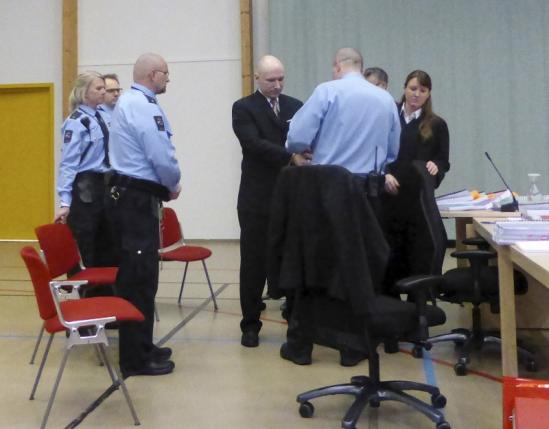 Mass killer Anders Behring Breivik has his handcuffs removed upon his arrival at the court room in Skien prison