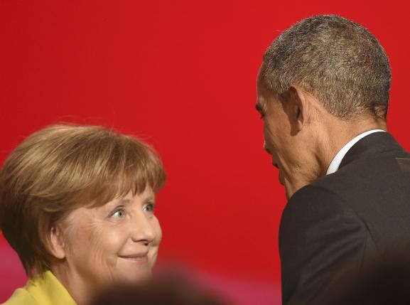 U.S. President Obama speaks to German Chancellor Merkel during the opening ceremony of the Hannover Messe in Hanover