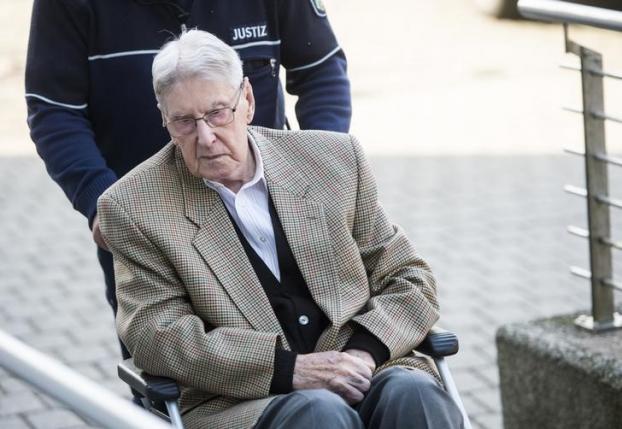 Defendant Hanning, a 94-year-old former guard at Auschwitz death camp, is brought to courtroom on a wheelchair before the continuation of his trial in Detmold