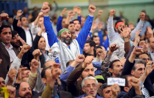 Workers chant slogans during a speech by Iran's Supreme Leader Ayatollah Ali Khamenei in Tehran