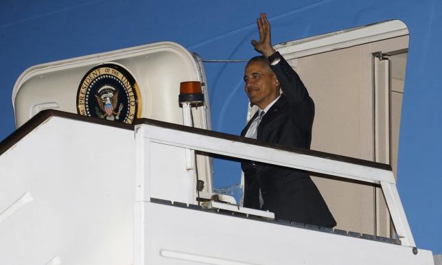 Obama walks down the steps of Air Force One as he arrives at Stansted Airport near London