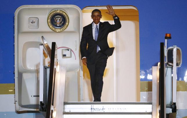 U.S. President Obama walks down the steps of Air Force One as he arrives at Stansted Airport near London, Britain