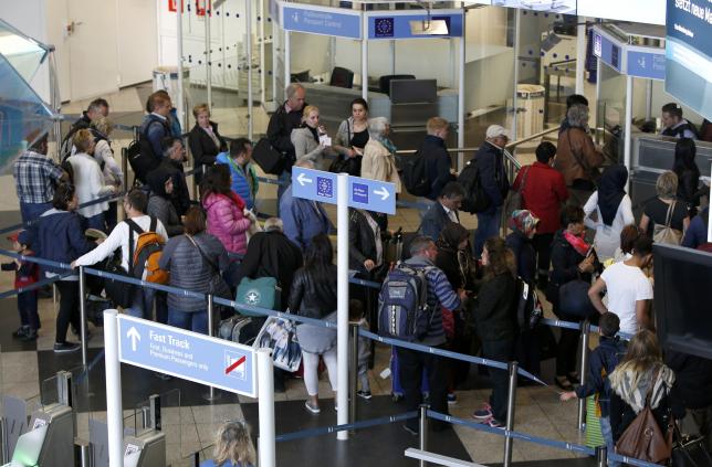 Passengers queue for a passport control in Munich airport
