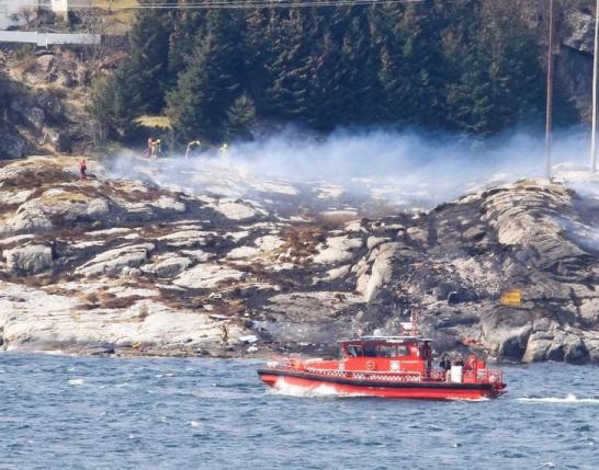Rescuers work at a site where a helicopter has crashed, west of the Norwegian city of Bergen