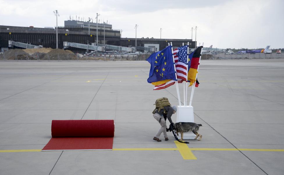 A security officer with a sniffer dog inspects the red carpet area ahead of the arrival of U.S. President Obama to Hanover