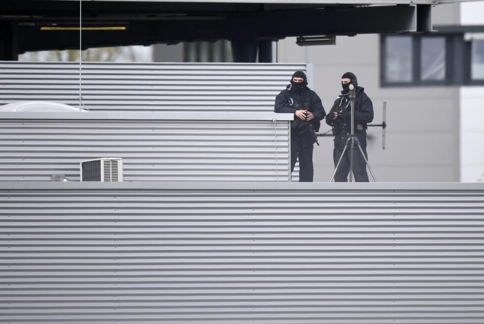 Security officers stay on the roof of the airport building ahead of U.S. President Obama visit to Hanover