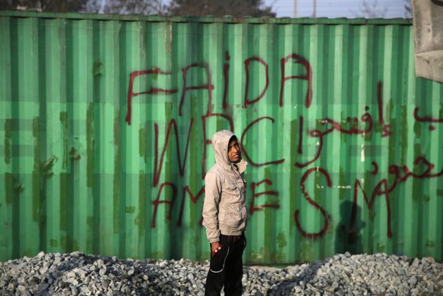 A child stands at a makeshift camp for migrants and refugees at the Greek-Macedonian border near the village of Idomeni
