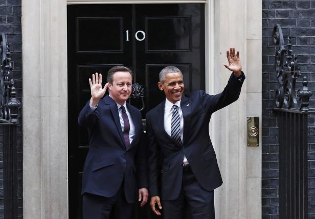 U.S. President Barack Obama and Britain's Prime Minister David Cameron wave as they stand at Number 10 Downing Street in London