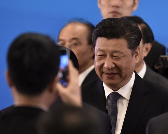 China's President Xi Jinping is photographed by a smartphone at the Diaoyutai State Guesthouse in Beijing